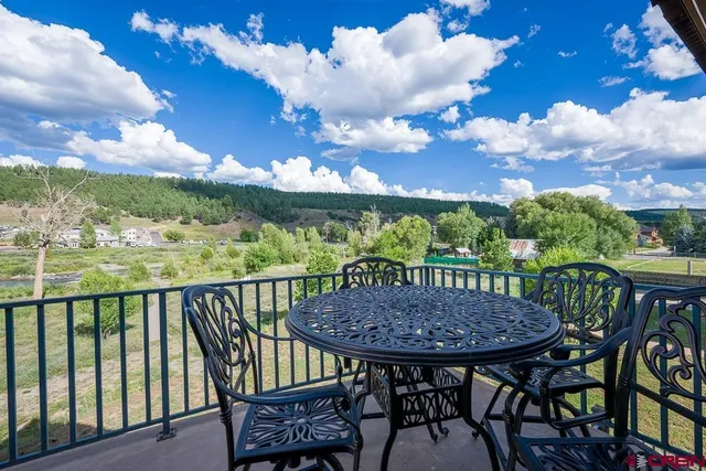 a view of a chairs and table in the balcony