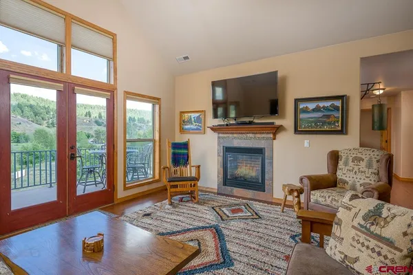 a living room with furniture fireplace and flat screen tv