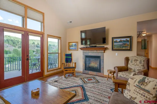 a living room with furniture fireplace and flat screen tv