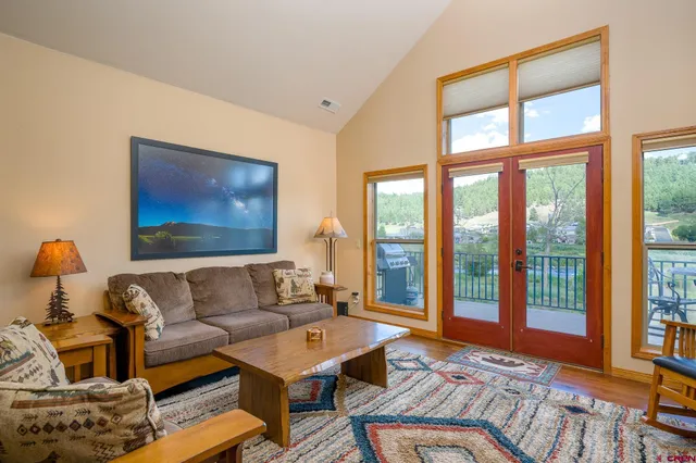 a living room with furniture and a floor to ceiling window