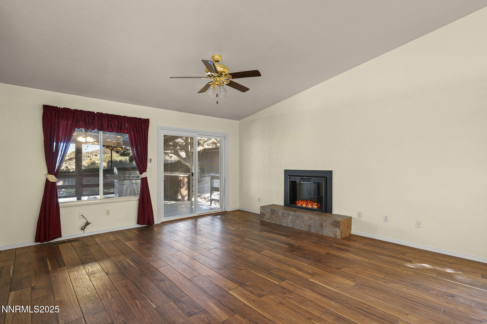 4663 Goodwin Road Sparks, NV 89436 - Photo 8 of 38 a view of empty room with wooden floor and fan