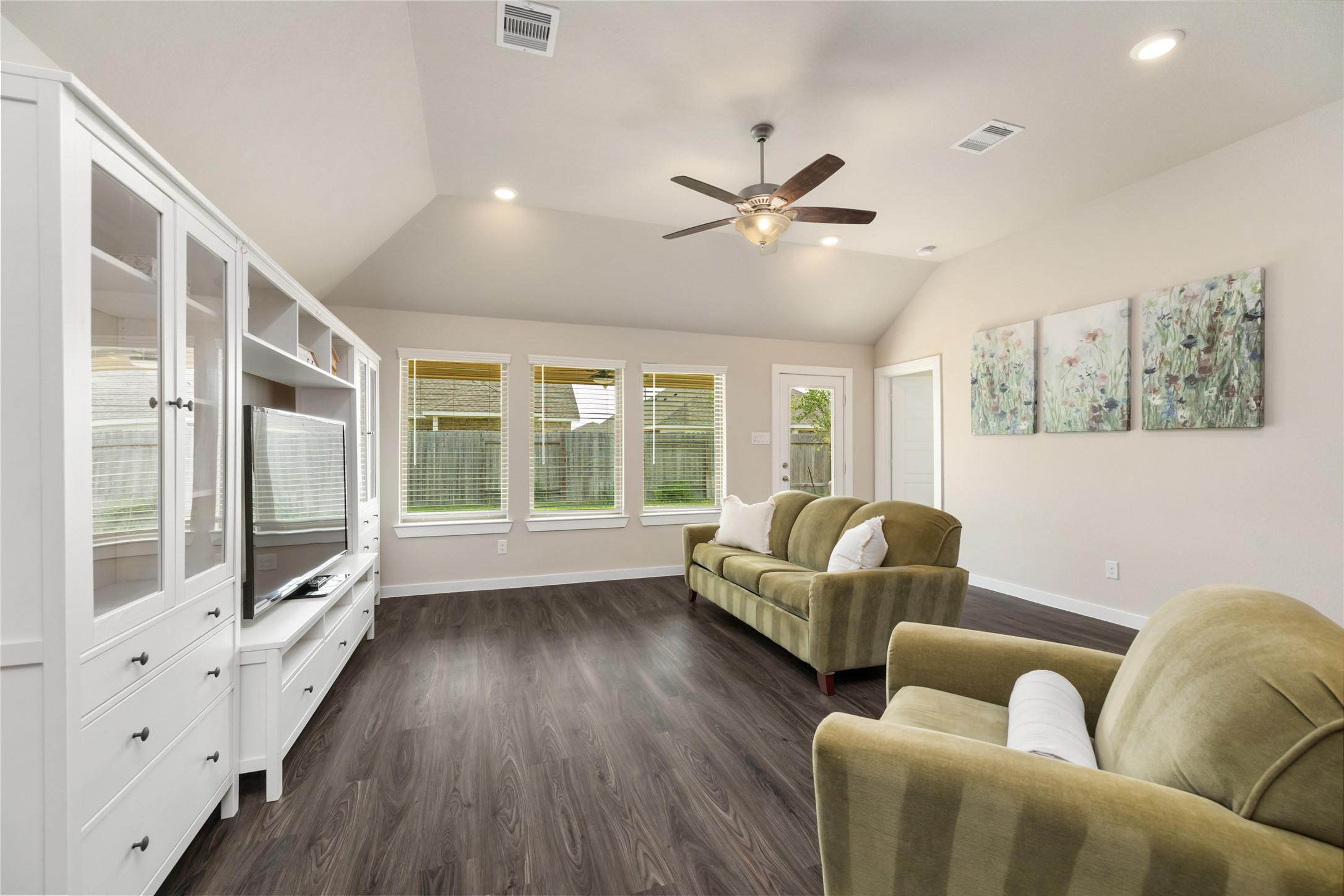 7622 Mistral Lane Baytown, TX 77523 - Photo 12 of 25 Natural light fills the living area. High ceilings make the home feel so much larger than it is.
