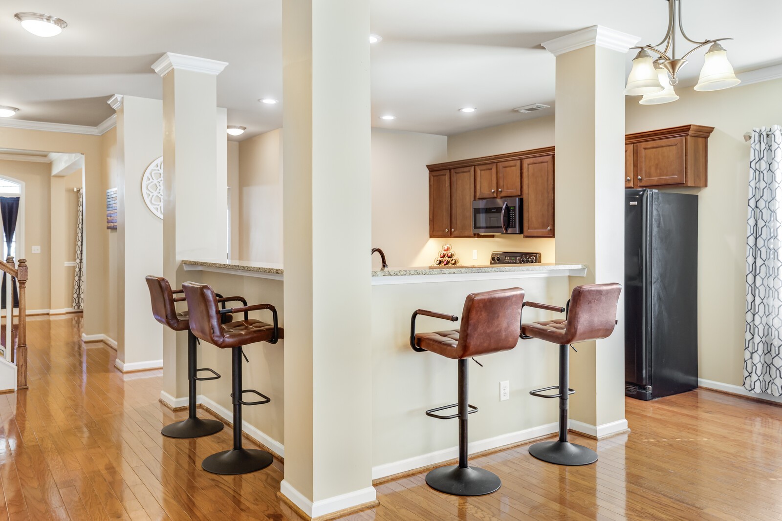 5239 New John Hagar Road Hermitage, TN 37076 - Photo 20 of 70 a kitchen with stainless steel appliances kitchen island granite countertop dining table chairs and a refrigerator