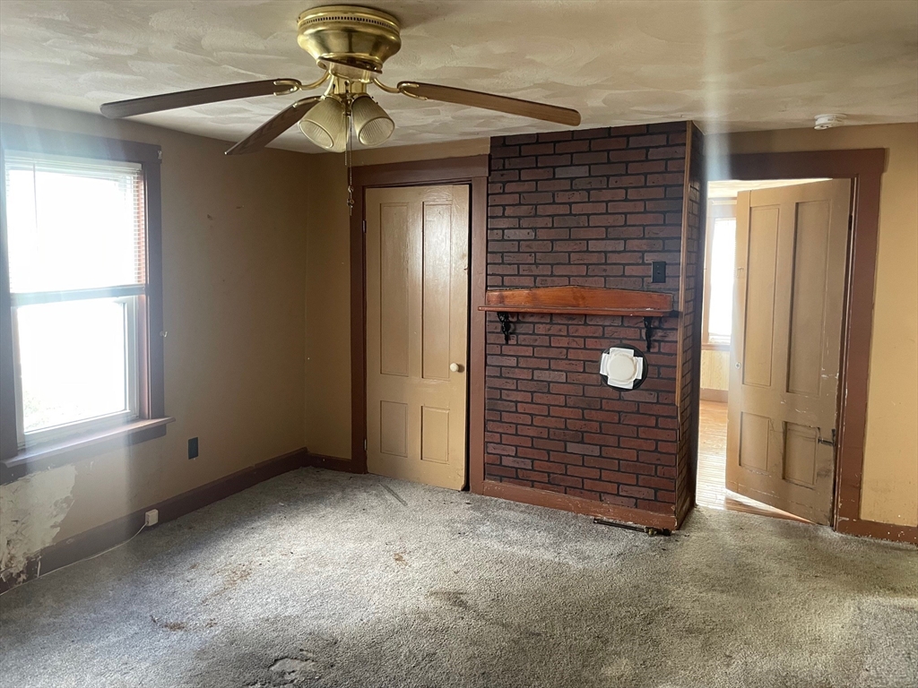 3216 North Main Street Fall River, MA 02720 - Photo 12 of 42 an empty room with windows and ceiling fan