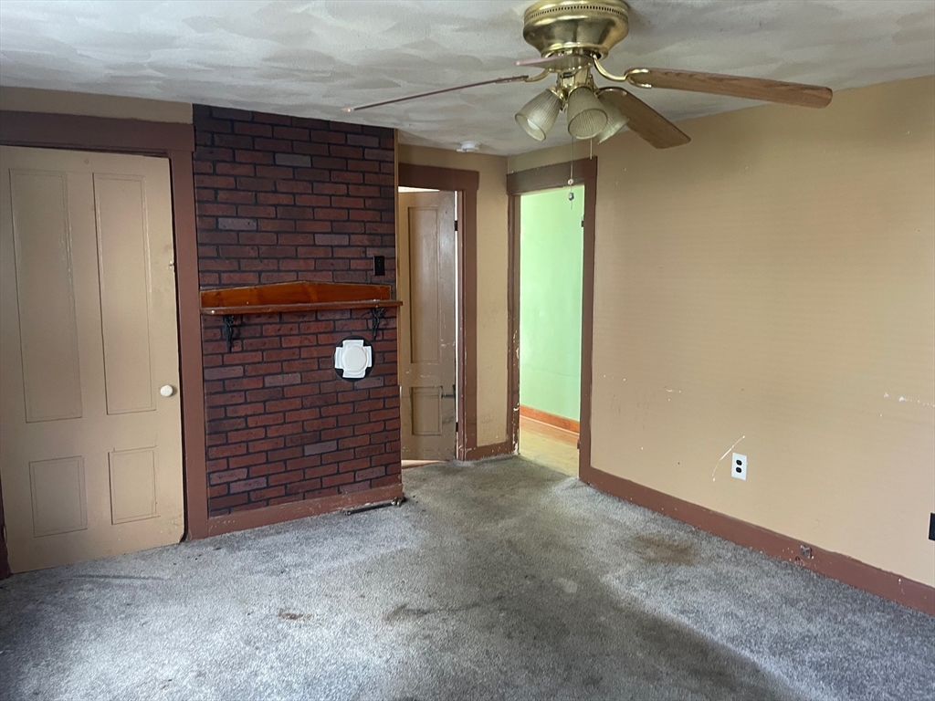 3216 North Main Street Fall River, MA 02720 - Photo 13 of 42 a view of an empty room with a ceiling fan and window