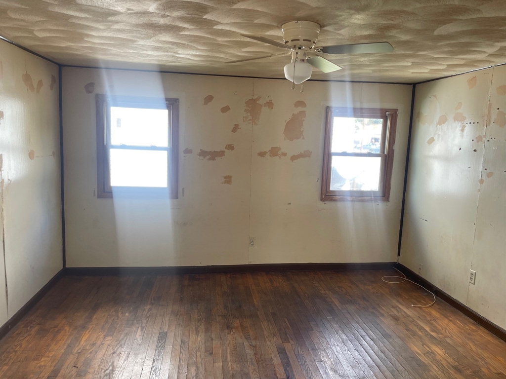 3216 North Main Street Fall River, MA 02720 - Photo 25 of 42 an empty room with wooden floor and windows
