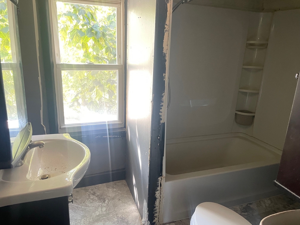 3216 North Main Street Fall River, MA 02720 - Photo 29 of 42 a bathroom with a tub sink and window