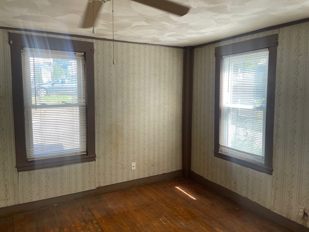 3216 North Main Street Fall River, MA 02720 - Photo 3 of 42 a view of an empty room with wooden floor and a window