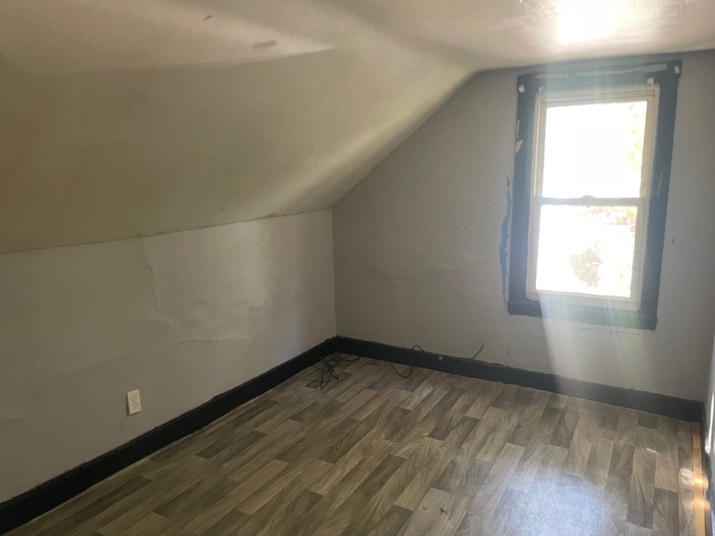 3216 North Main Street Fall River, MA 02720 - Photo 31 of 42 an empty room with wooden floor and windows