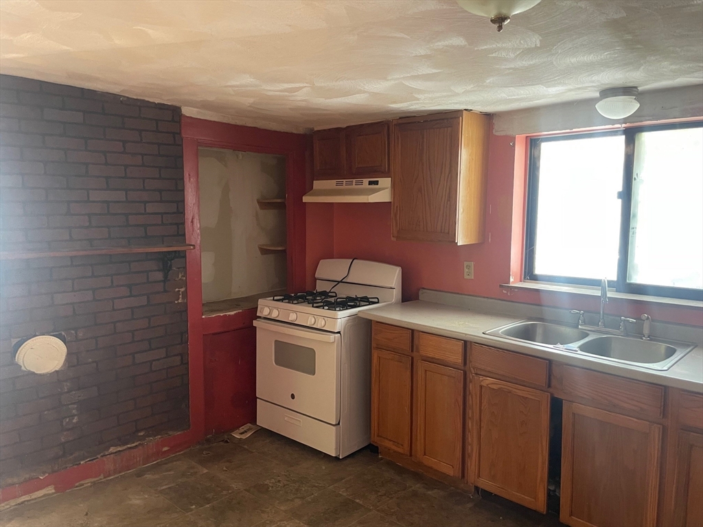 3216 North Main Street Fall River, MA 02720 - Photo 9 of 42 a kitchen that has a sink and a stove