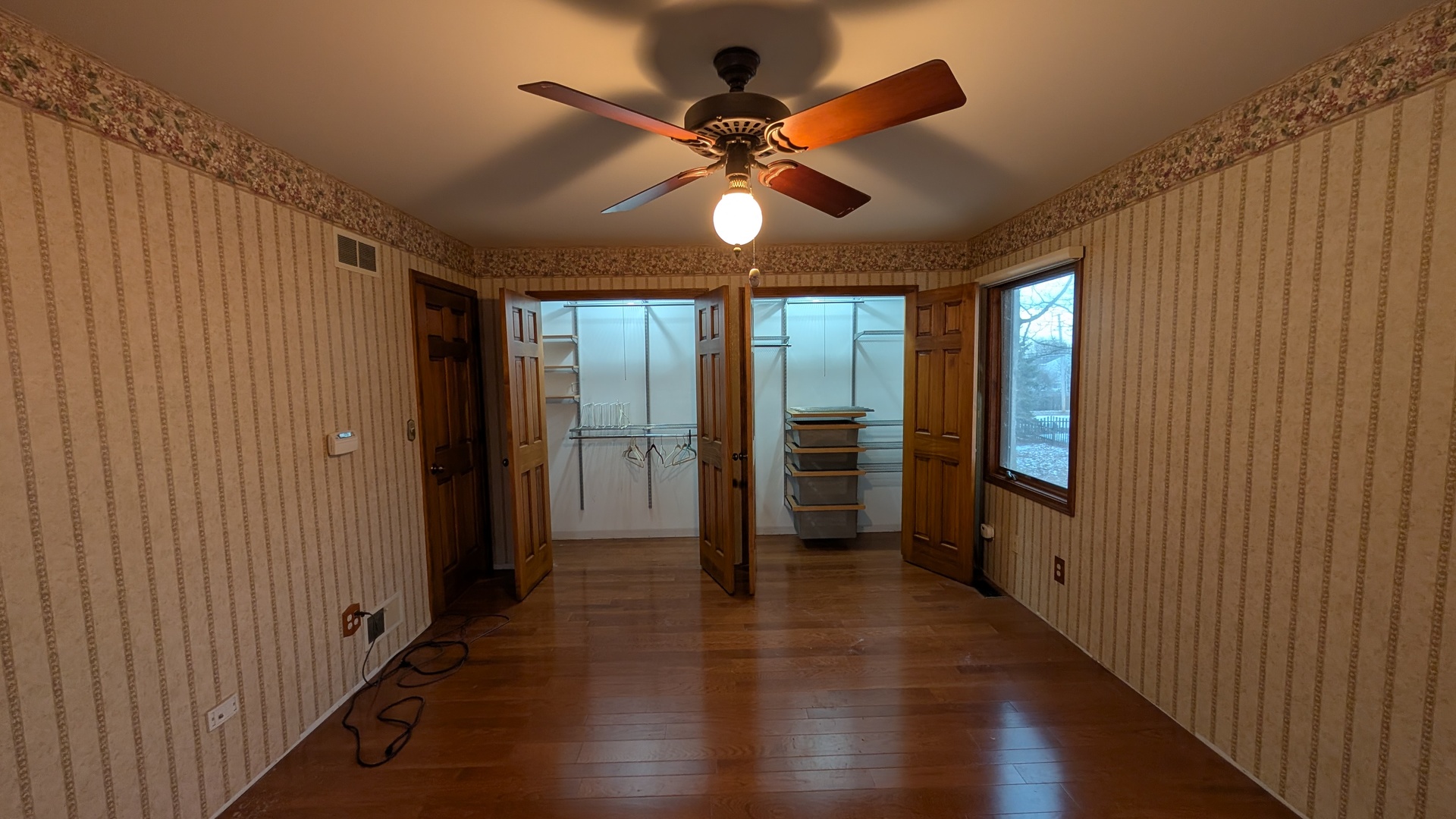 1102 O'Plaine Road Waukegan, IL 60085 - Photo 21 of 41 an empty room with wooden floor fan and windows