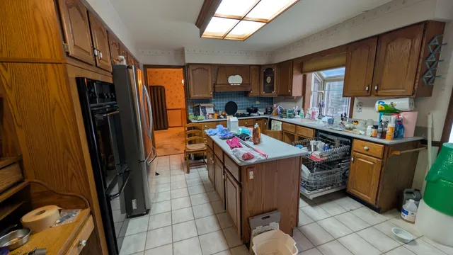a kitchen that has a lot of cabinets and refrigerator