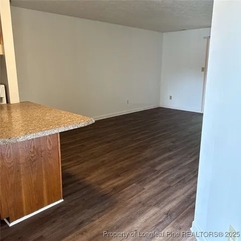 an empty room with wooden floor