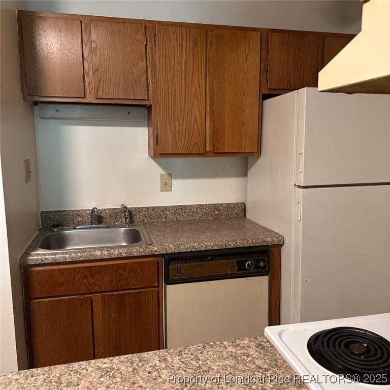 6400 Starbrook Drive, Unit 7 Fayetteville, NC 28304 - Photo 4 of 12 a kitchen with a sink and a refrigerator