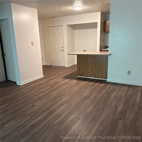 a view of a room with wooden floor