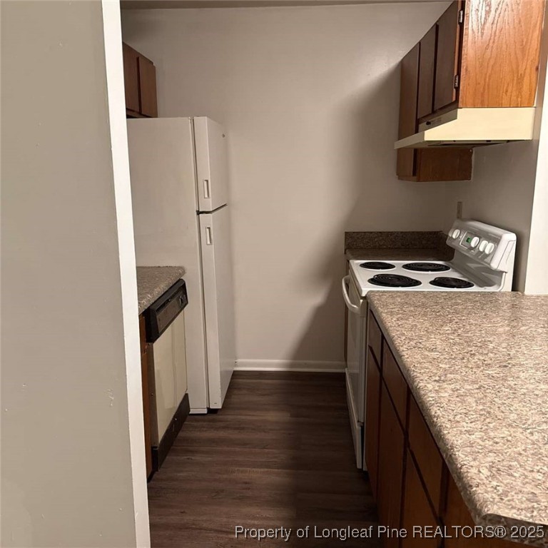 6400 Starbrook Drive, Unit 7 Fayetteville, NC 28304 - Photo 7 of 12 a kitchen with granite countertop a refrigerator a stove and wooden floor