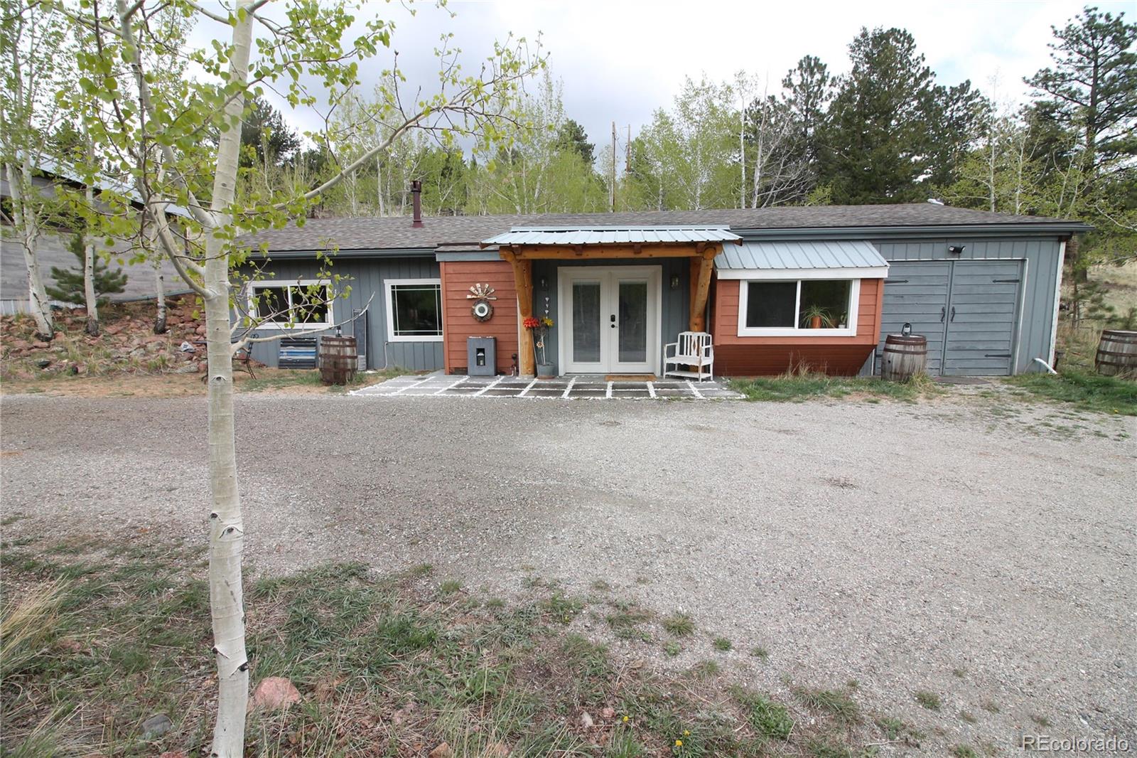 388 Clark Road Bailey, CO 80421 - Photo 2 of 50 a front view of house with yard space and seating