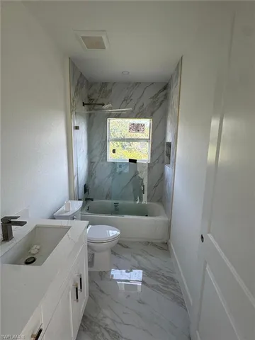 a bathroom with a sink a toilet and a bathtub