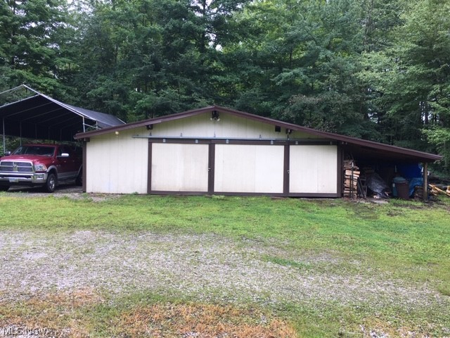 15429 Tavern Road Burton, OH 44021 - Photo 33 of 34 The large 24 x 36 pole barn has a new metal roof (2018) and provides camper parking with 30 amp service on one side and a bay for firewood on the other side.