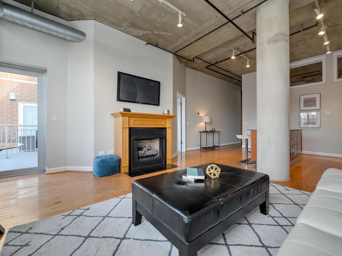 111 South Morgan Street, Unit 811 Chicago, IL 60607 - Photo 12 of 21 a living room with furniture and a fireplace