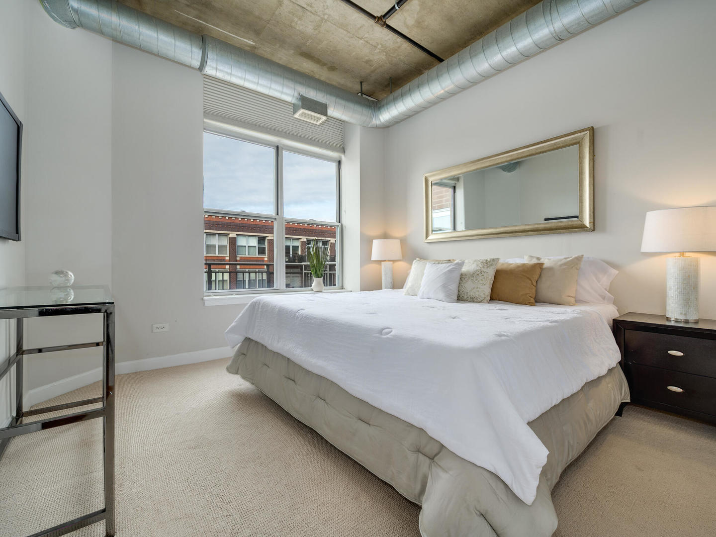 111 South Morgan Street, Unit 811 Chicago, IL 60607 - Photo 13 of 21 a bedroom with a bed and a night stand