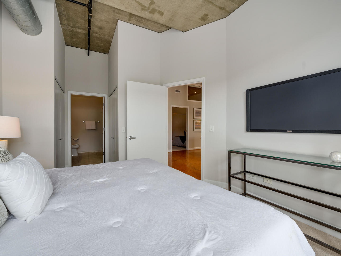 111 South Morgan Street, Unit 811 Chicago, IL 60607 - Photo 14 of 21 a bedroom with a bed and a flat screen tv