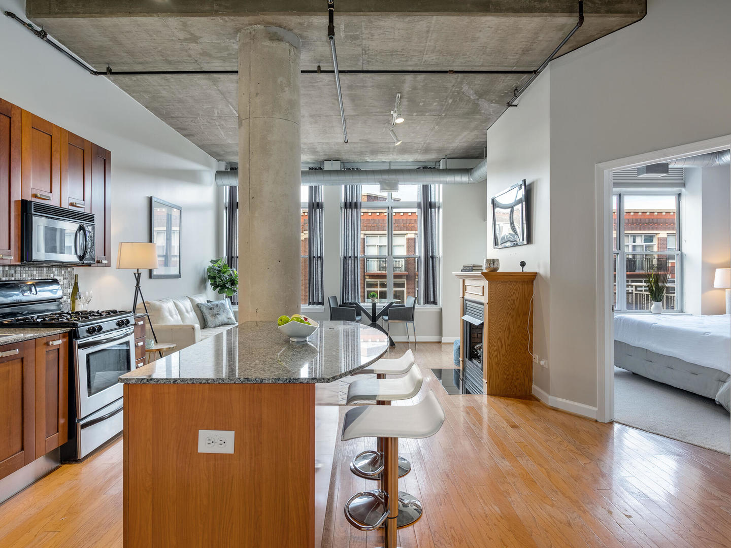 111 South Morgan Street, Unit 811 Chicago, IL 60607 - Photo 4 of 21 a view of a dining room with furniture window and wooden floor