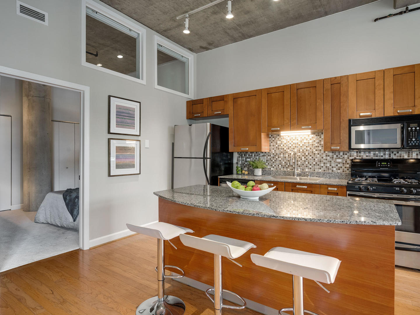 111 South Morgan Street, Unit 811 Chicago, IL 60607 - Photo 6 of 21 a kitchen with kitchen island a counter top space a sink and appliances