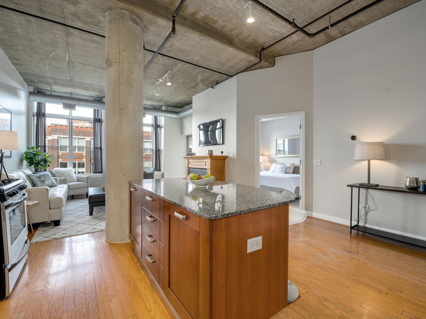 111 South Morgan Street, Unit 811 Chicago, IL 60607 - Photo 7 of 21 a kitchen with stainless steel appliances granite countertop a sink stove and wooden floor
