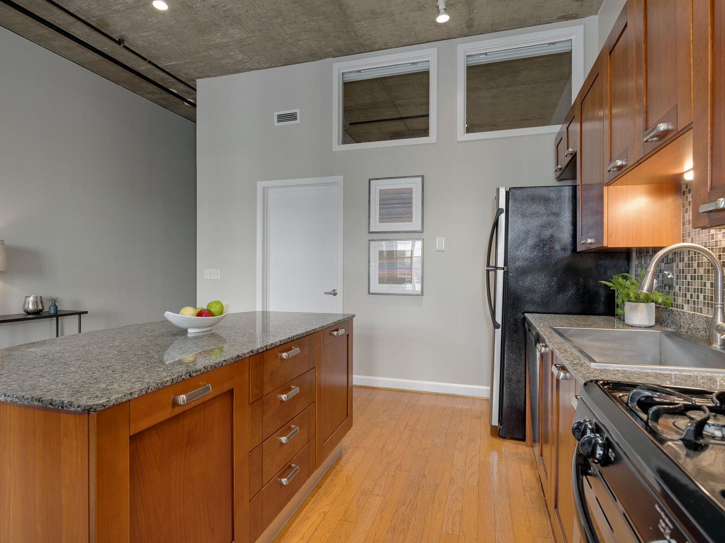 111 South Morgan Street, Unit 811 Chicago, IL 60607 - Photo 8 of 21 a kitchen with stainless steel appliances granite countertop a sink stove and refrigerator