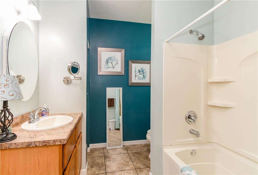 601 Virginia Avenue Rochester, PA 15074 - Photo 15 of 23 a bathroom with a granite countertop sink and a mirror