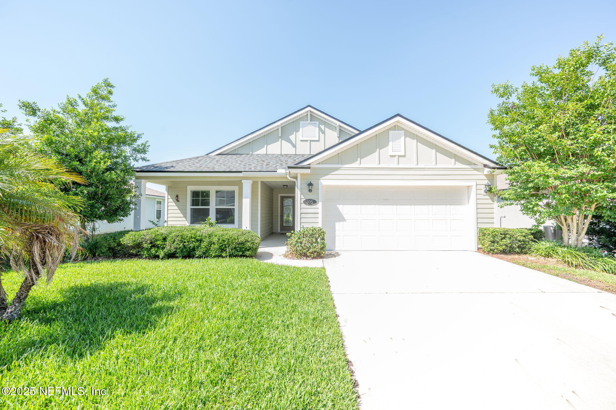 305 Green Turtle Lane St. Augustine, FL 32086 - Photo 1 of 39 a front view of a house with a yard and garage