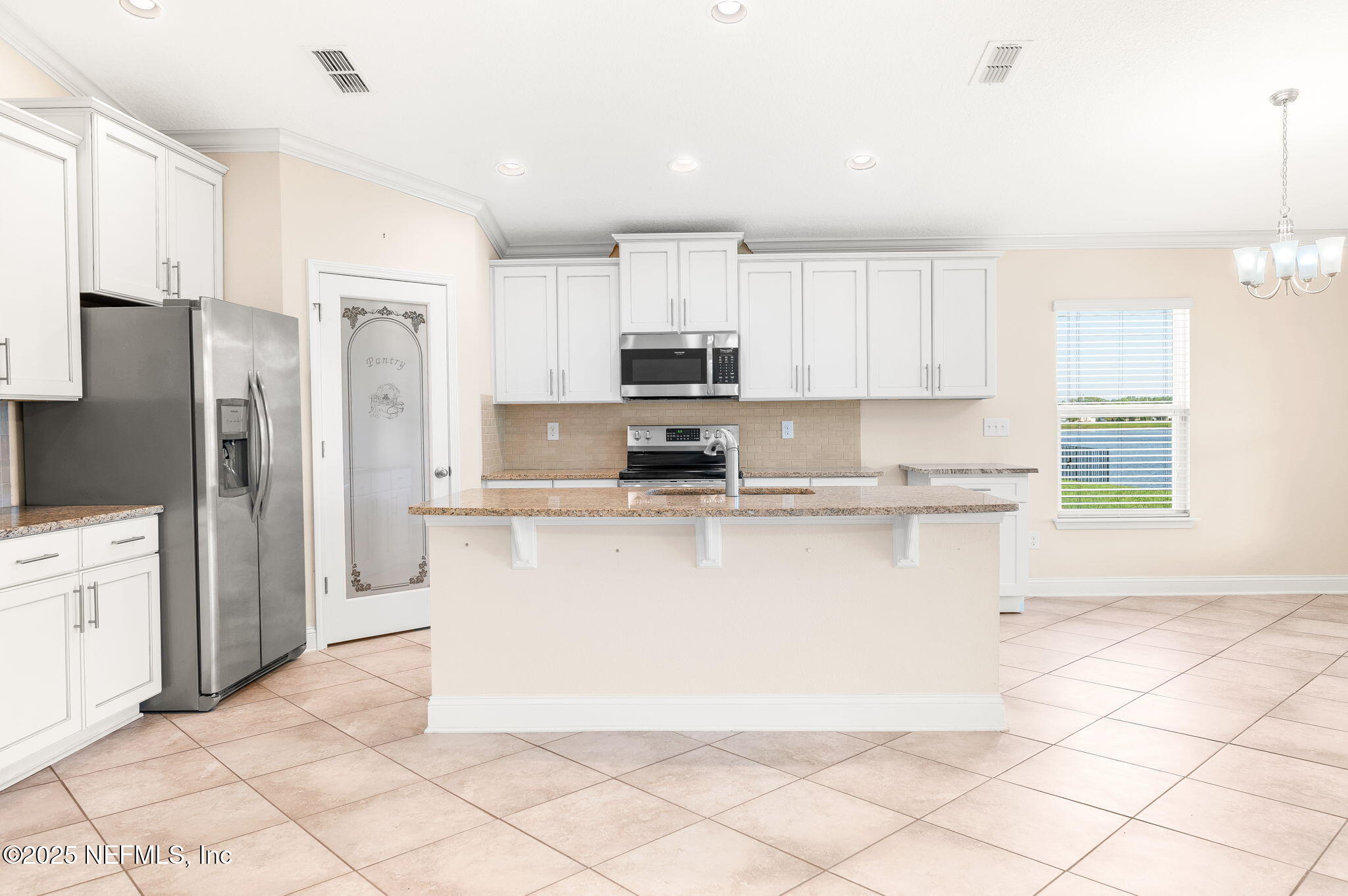 305 Green Turtle Lane St. Augustine, FL 32086 - Photo 9 of 39 a kitchen with stainless steel appliances granite countertop a refrigerator a stove a sink and white cabinets