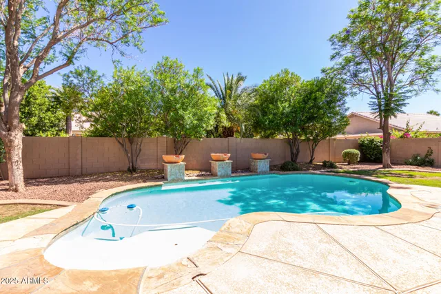 a view of a backyard with plants and a patio