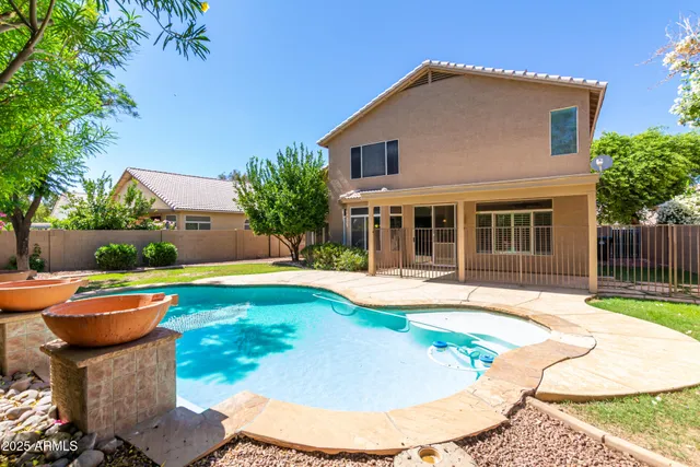 a view of a house with swimming pool and sitting area
