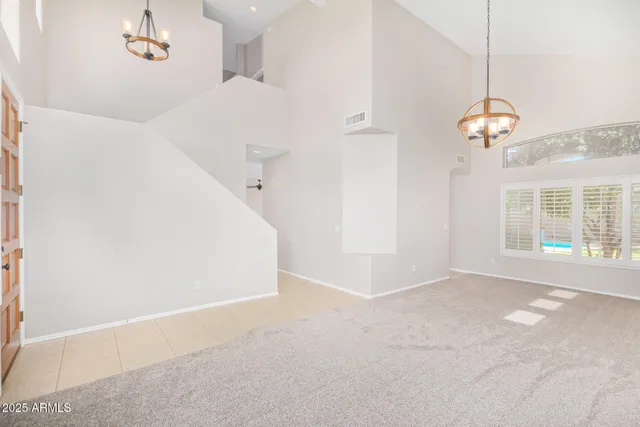 a view of a room with a ceiling fan and a window