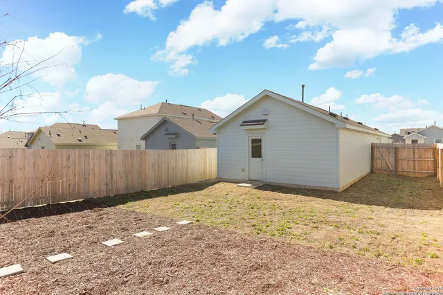 a view of a backyard of the house