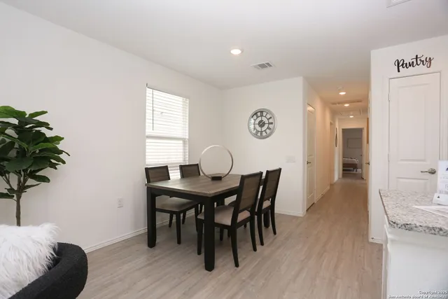a view of a dining room with furniture and wooden floor