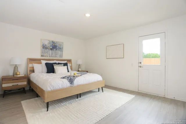 a bedroom with a bed and a night stand