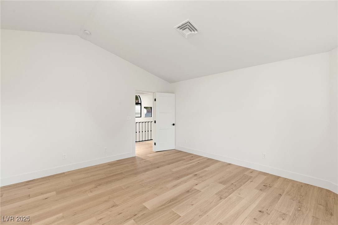 2316 Prometheus Court Henderson, NV 89074 - Photo 46 of 92 Unfurnished room featuring visible vents, baseboards, light wood-style floors, and vaulted ceiling