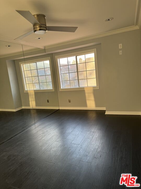 12030 Falcon Crest Way Porter Ranch, CA 91326 - Photo 13 of 33 an empty room with wooden floor and windows