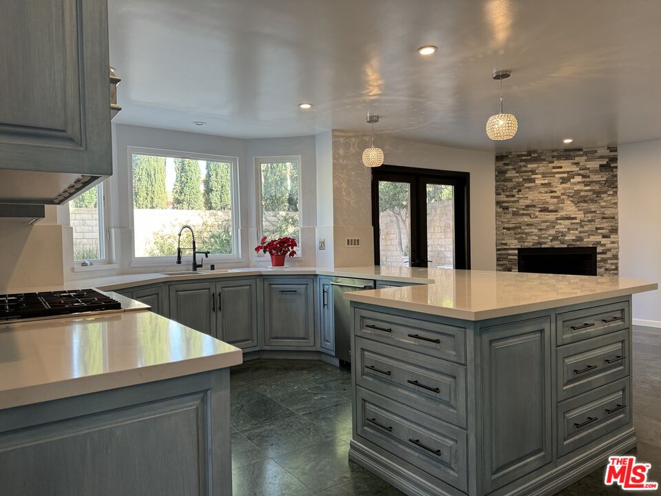 12030 Falcon Crest Way Porter Ranch, CA 91326 - Photo 2 of 33 a kitchen with kitchen island a sink stove and cabinets