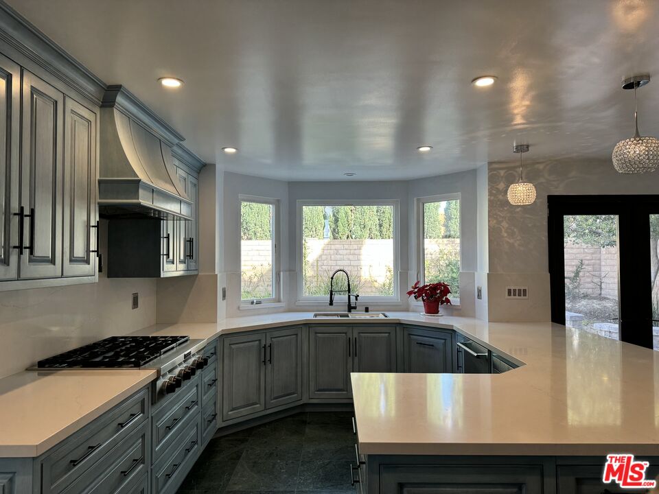 12030 Falcon Crest Way Porter Ranch, CA 91326 - Photo 3 of 33 a kitchen with stainless steel appliances a stove a sink a microwave a refrigerator and cabinets