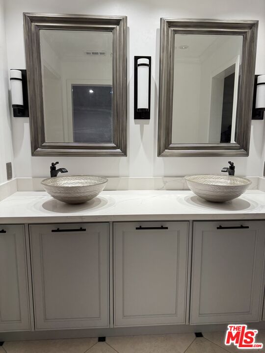 12030 Falcon Crest Way Porter Ranch, CA 91326 - Photo 5 of 33 a bathroom with a double vanity sink and a mirror