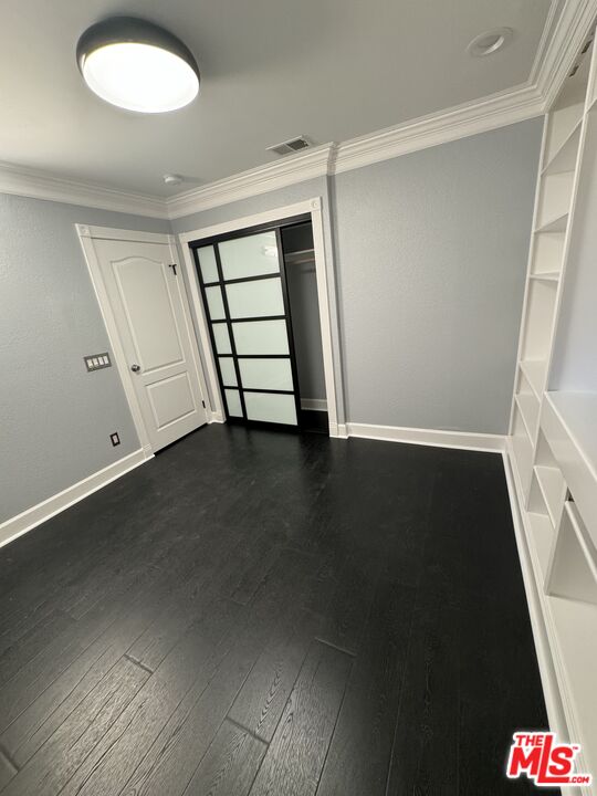 12030 Falcon Crest Way Porter Ranch, CA 91326 - Photo 10 of 33 an empty room with wooden floor and windows