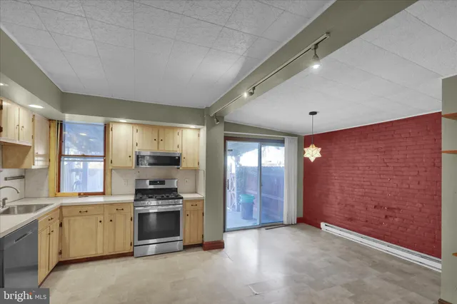 a view of a room with wooden floor and a ceiling fan