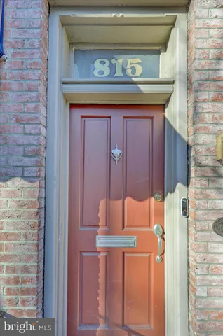 a brick building with a bench and a window