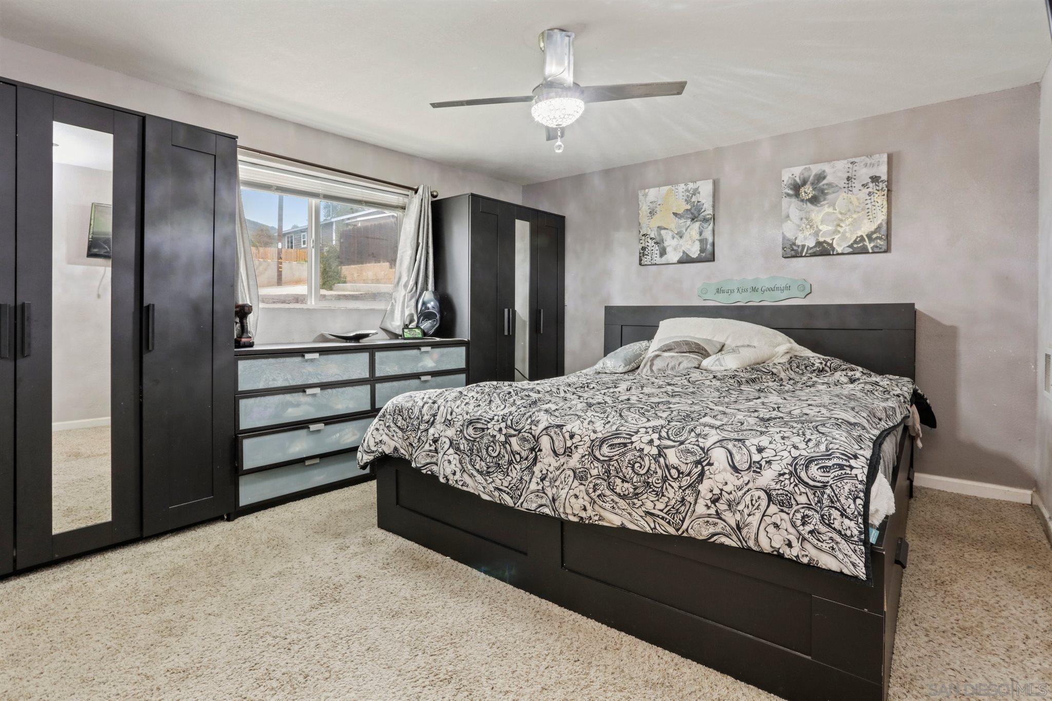 8521 Gaena Road Lakeside, CA 92040 - Photo 12 of 27 a living room with a bed furniture and paintings on the wall