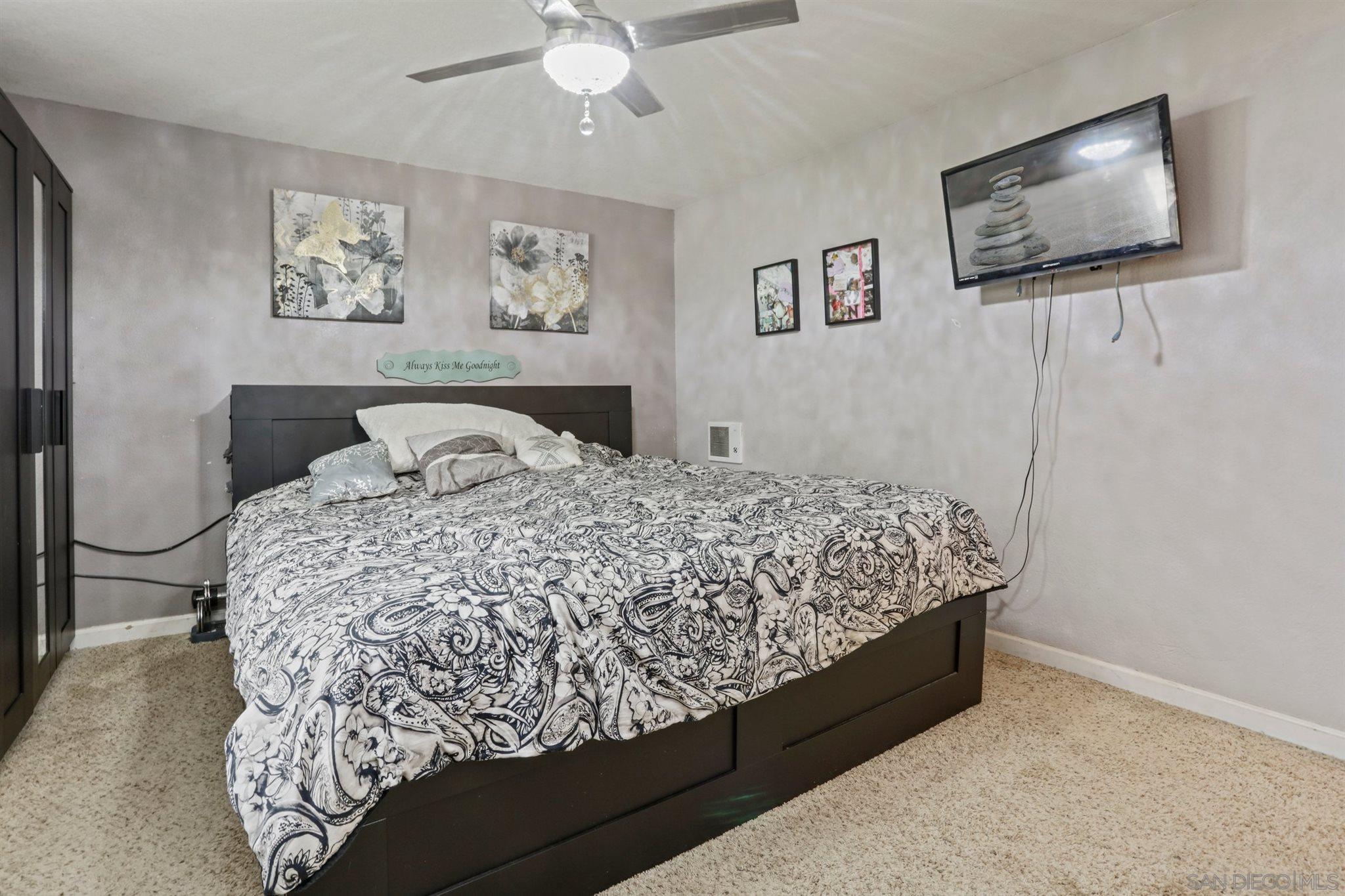 8521 Gaena Road Lakeside, CA 92040 - Photo 13 of 27 a bed sitting in a bedroom and a painting on the wall