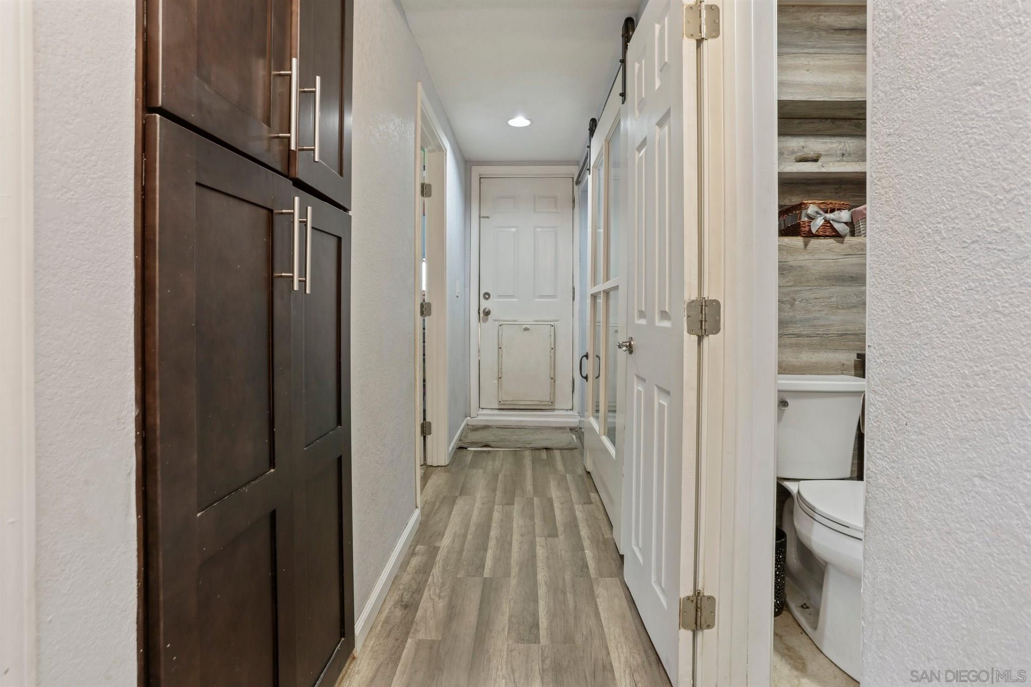 8521 Gaena Road Lakeside, CA 92040 - Photo 14 of 27 a view of a hallway with wooden floor and staircase